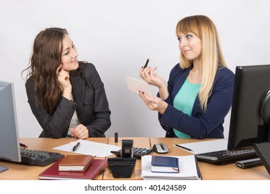 Office employee demonstrates lipstick colleague at the desk - Shutterstock ID 401424589