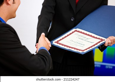 Office: Employee Gets A Certificate Of Achievement - Powered by Shutterstock