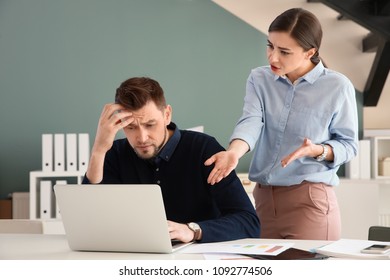 Office Employees Having Argument At Workplace