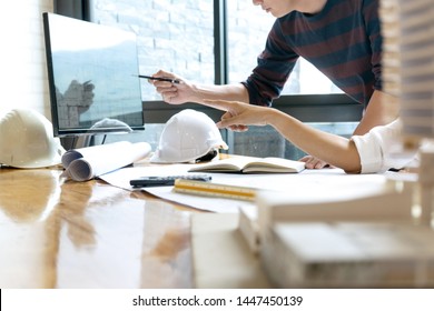 in the office  engineer or architectural project, two engineering or architecture discussing and working on blueprint with architect equipment, Construction concept.