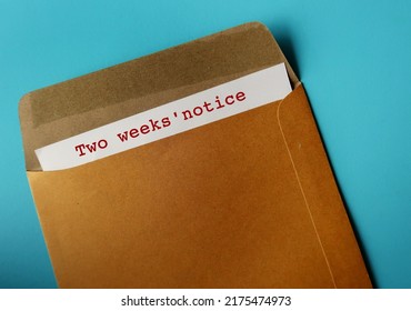 Office envelope and document with words - Two weeks' notice, means employee courtesy to give employer time to prepare for resignation and hiring someone else - Shutterstock ID 2175474973
