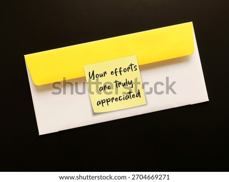 Office envelope with note written YOUR EFFORTS ARE TRULY APPRECIATED -Employee Recognition or acknowledging rewarding employees for contributions effort and achievements to show they are valued