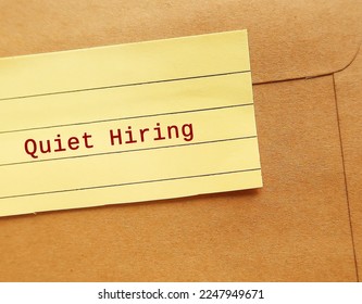 Office envelope sealed with text note QUIET HIRING - HR buzz word of recruiting strategy, employees who stand out by going above and beyond get more attention, money, praise, and more opportunities - Shutterstock ID 2247949671