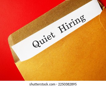 Office envelope with text document QUIET HIRING - HR buzz word of recruiting strategy, employees who stand out by going above and beyond get more attention, money, praise, and more opportunities