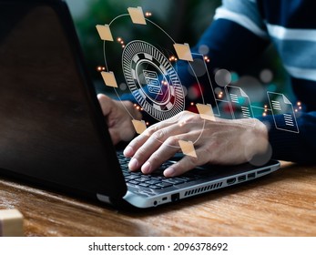 In The Office, An IT Expert Is Setting Up A Document Management System (DMS) On A Laptop Computer. Corporate File Archiving Software