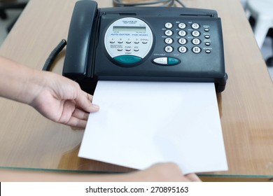 Office fax machine with a business woman with print copy paper