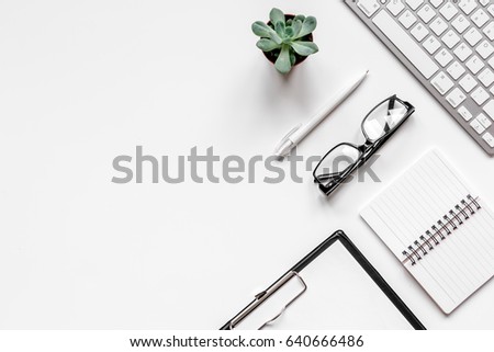 office flat lay with keyboard, glasses, notebook on white background top view mockup