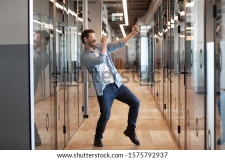 In office hallway dancing happy worker got promotion celebrating success higher rate of pay receive financial bonus, candidate for post was hired, employee feels excited work done, its Friday concept