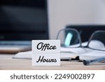 Office Hours inscription on workplace background.