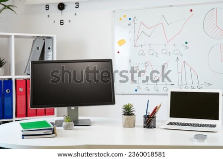 Office interior desk with pc computer laptop pen notepad whiteboard. Startup business office interior 