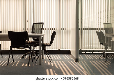 Office Interior With Light Shining Through Window Blinds