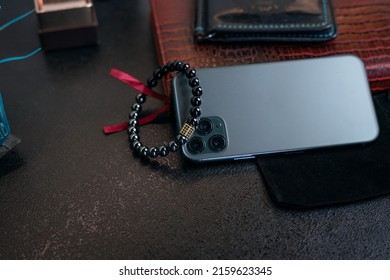 Office Items With Red Notepad, Mobile Phone And Wrist Bracelet, Wallet, Top View.