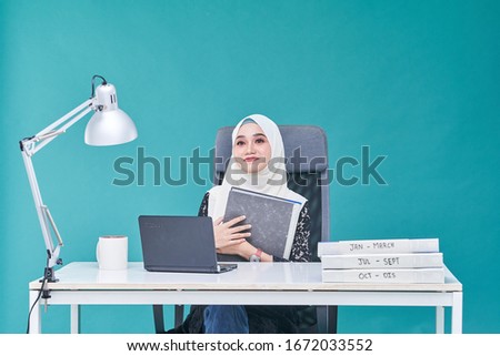 Office Lady with bundle of file on the table and laptop