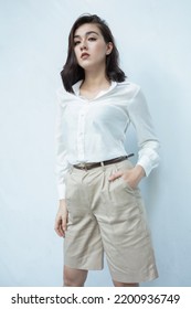 Office lady wears white long sleeve shirt and khaki shorts with belt - Shutterstock ID 2200936749