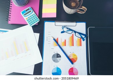 Office Laptop Business Financial Document Chart And Graph On Wooden Table With Coffee Cup. Flat Lay Notebook Computer Laptop On Office Desk. No People Business Graph Chart Mockup On Business Workspace