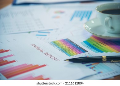 Office Laptop Business Financial Document Chart And Graph On Wooden Table With Coffee Cup. Flat Lay Notebook Computer Laptop On Office Desk. No People Business Graph Chart Mockup On Business Workspace