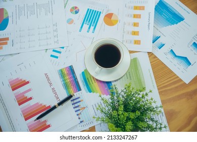 Office Laptop Business Financial Document Chart And Graph On Wooden Table With Coffee Cup. Flat Lay Notebook Computer Laptop On Office Desk. No People Business Graph Chart Mockup On Business Workspace