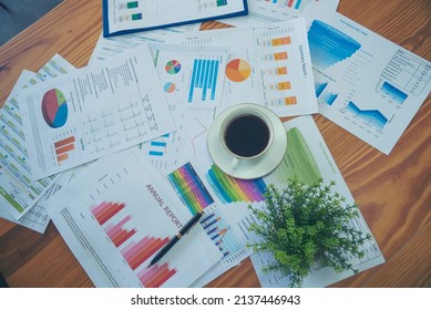 Office Laptop Business Financial Document Chart And Graph On Wooden Table With Coffee Cup. Flat Lay Notebook Computer Laptop On Office Desk. No People Business Graph Chart Mockup On Business Workspace