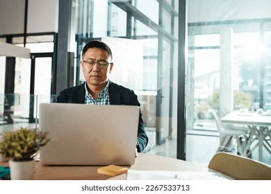 Office laptop, typing and senior man reading feedback review of social media, customer experience or ecommerce website. Data analytics, infographic or Asian marketing worker analysis of online survey - Powered by Shutterstock