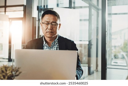 Office laptop, typing and senior man reading feedback review of social media, customer experience or ecommerce website. Data analytics, infographic or Asian marketing worker analysis of online survey - Powered by Shutterstock