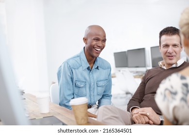 Office Laughs. Three Coworkers Talking In An Informal Meeting Together.