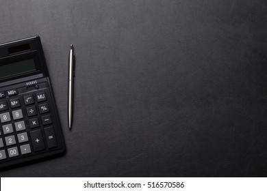 Office leather desk table with calculator and pen. Top view with copy space - Shutterstock ID 516570586