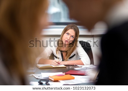 Office life.The girl overhears the conversation of her colleagues at work in the office