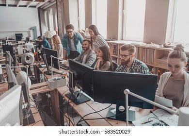 Office Life. Group Of Young Business People In Smart Casual Wear Working Together In Creative Office