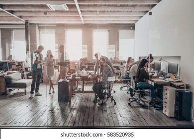 Office life. Group of young business people in smart casual wear working together in creative office - Shutterstock ID 583520935