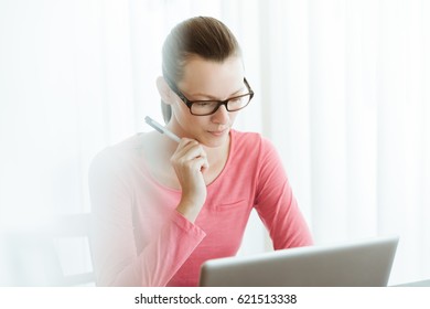 Office Life. Woman Using Office Computer In A Bright Office Setting. 