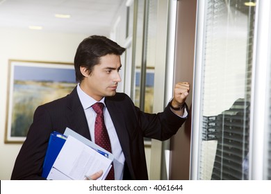 Office Life: Young Employee Knocking On His Boss Door