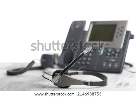 Office light background VOIP headset headphones telephone on office desk concept for communication, it support, call center and customer service