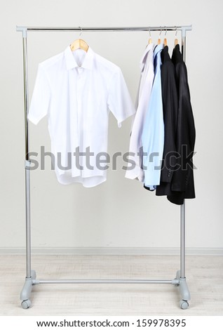 Office  male clothes on hangers, on gray background