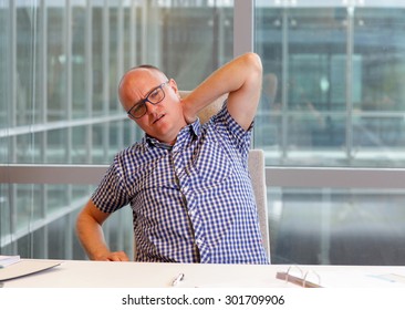 Office Male Worker Suffering From Painful Tense Neck Muscles