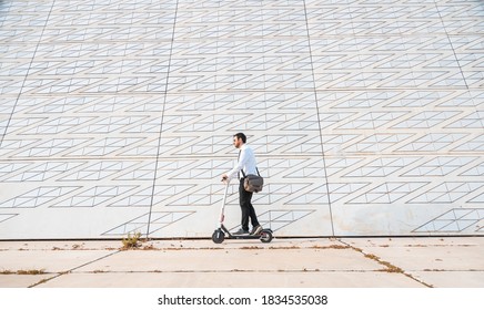 office man goes to work on electric scooter - Powered by Shutterstock