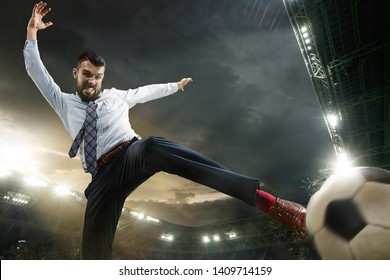 Office Man As A Soccer Or Football Player At The Stadium. Kicking A Ball For A Goal While Playing For The Favourite Team He Bet On. Concept Of Business, Finance, Betting, Win, Action And Movement.