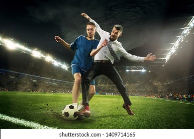 Office Man As A Soccer Or Football Player At The Stadium. Kicking A Ball For A Goal While Playing For The Favourite Team He Bet On. Concept Of Business, Finance, Betting, Win, Action And Movement.