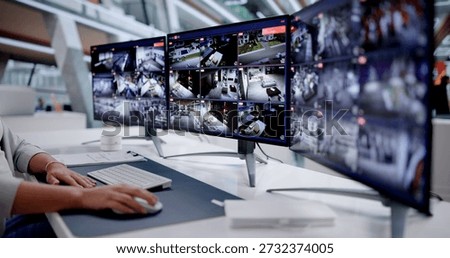 Office Manager Monitors Multiple CCTV Cameras For Security Purposes