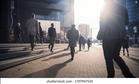 Office Managers and Business People Commute to Work in the Morning or from Office on a Sunny Day on Foot. Pedestrians are Dressed Smartly. Successful People Walking in Downtown. Cloudy Day in Downtown - Powered by Shutterstock