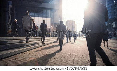 Office Managers and Business People Commute to Work in the Morning or from Office on a Sunny Day on Foot. Pedestrians are Dressed Smartly. Successful People Walking in Downtown. Cloudy Day in Downtown