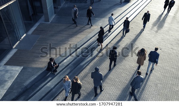 Office Managers and Business People Commute to\
Work in the Morning or from Office on a Sunny Day on Foot.\
Pedestrians are Dressed Smartly. Successful People Walking in\
Downtown. Shot from\
Above.