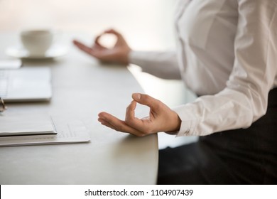 Office meditation for reducing work stress relief concept, female hands in mudra close up view, business woman practicing yoga at workplace for mindfulness development. mental health and balance