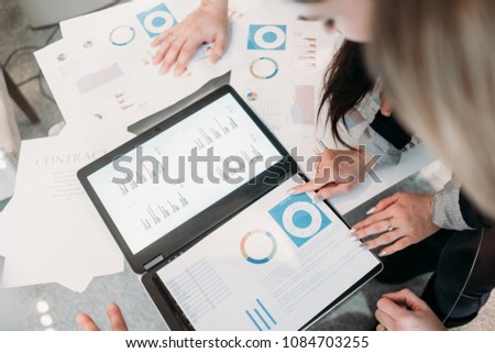 office meeting. business team brainstorming. group of workers study documents with graphs and diagrams. information analysis