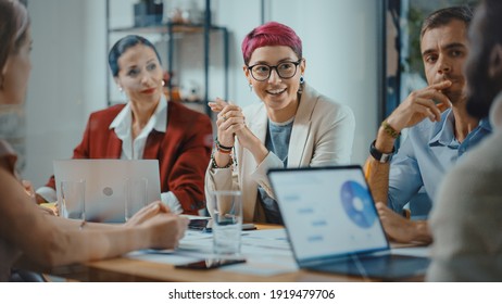 Office Meeting in Conference Room: Beautiful Specialist with Short Pink Hair Talks about Firm Strategy with Diverse Team of Professional Businesspeople. Creative Start-up Team Discusses Big Project - Shutterstock ID 1919479706