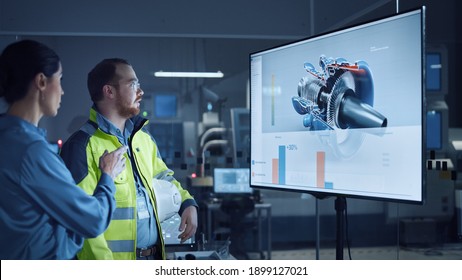 Office Meeting: Confident Female Manager Talks To Male Engineer, Watching Interactive Digital Whiteboard TV That Shows New Sustainable Eco-Friendly Engine 3D Concept.