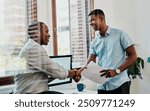 Office, meeting and handshake for collaboration, planning and deal with proposal for report. African men, smile and creative small business, teamwork and presentation for partnership or b2b project