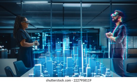 Office Online Meeting Video Conference: Businesswoman Wearing Virtual Reality Glasses to Talk With Real Estate Developer about Megapolis Project in Augmented Reality Metaverse. City Blueprint Hologram - Powered by Shutterstock