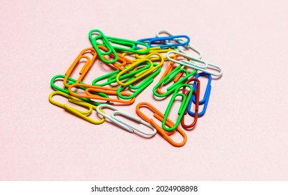 Office paper clips isolated on colored background. Pink, red, blue, green, orange colorful Plastic paperclips documents staple attach tools. - Shutterstock ID 2024908898