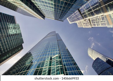 Office and residential skyscrapers on bright sun and clear blue sunset sky background. Commercial real estate. Modern business city district. Office buildings exterior. Financial city district.  - Shutterstock ID 1406669933