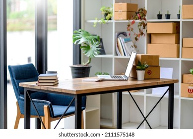 Office Room With Desk And Laptop Computer Chair On The Small Business Owner Desk. The Desk Of An Online Merchandising Operator.